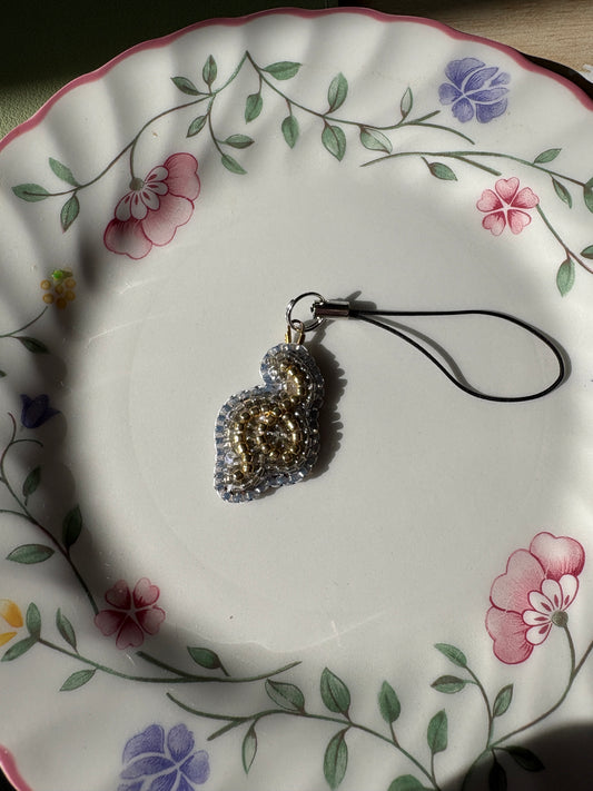 single thread of gold phone charm