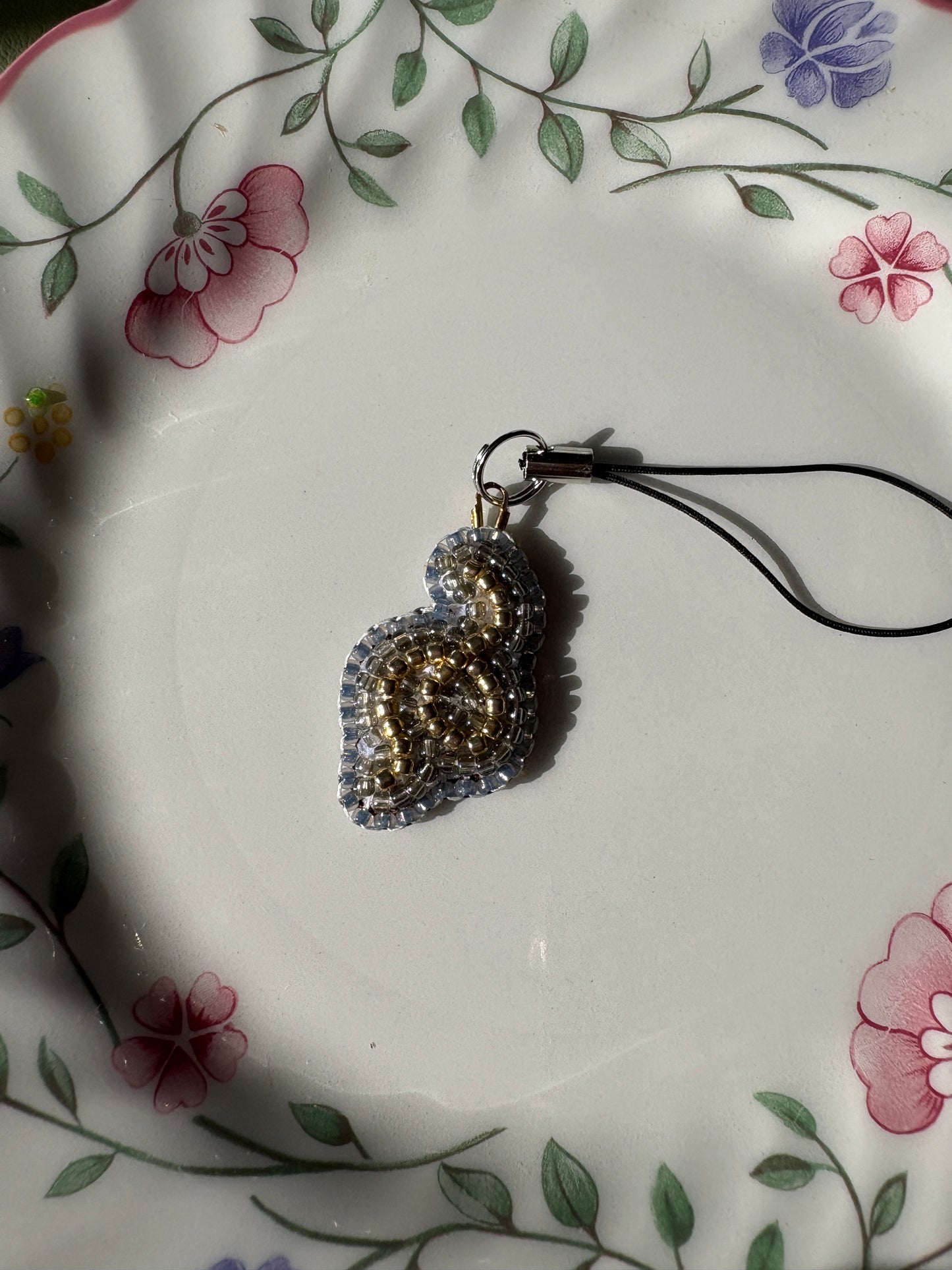 single thread of gold phone charm